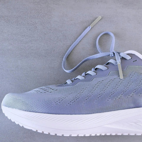 Upgrade Your Daily Drip With Top Tier Metal Alloy Shoe Lace Tips on light blue trainer shoe with grey laces.