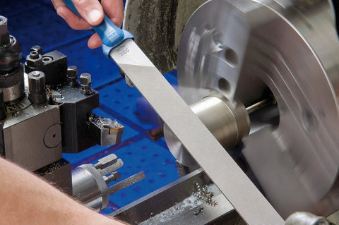 Person using 5 Piece Machinist File Set With Ergonomic Handles And Plastic Pouch 8 Inch Bastard Coarse Cut for metalworking
