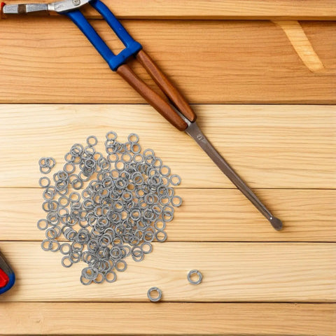 Stainless Steel Spring Washer Kit 200 Pcs For Screws And Bolts Pro Grade shown with pliers on wooden surface