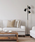 Annecy 58 Inch Rustic Floor Lamp With 3 Lights, Dark Bronze Finish, Seeded Glass Shades in a living room setting