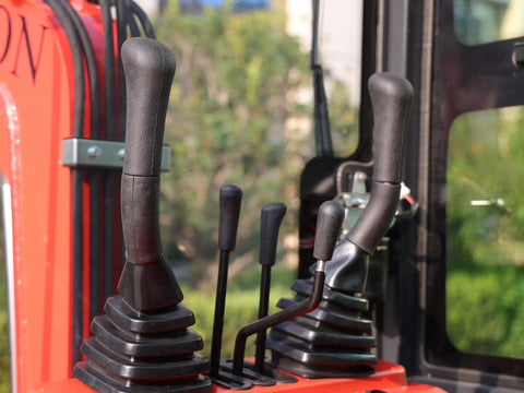 Close-up of controls on Compact 1.1 Ton Mini Excavator With Enclosed Cab And Hydraulic Thumb Attachment for precise operation.