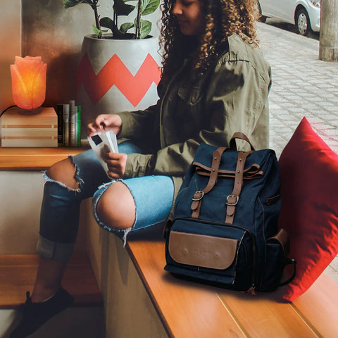 Flower Shape Pink Himalayan Salt Lamp with wood base on table near person with backpack in cozy setting.