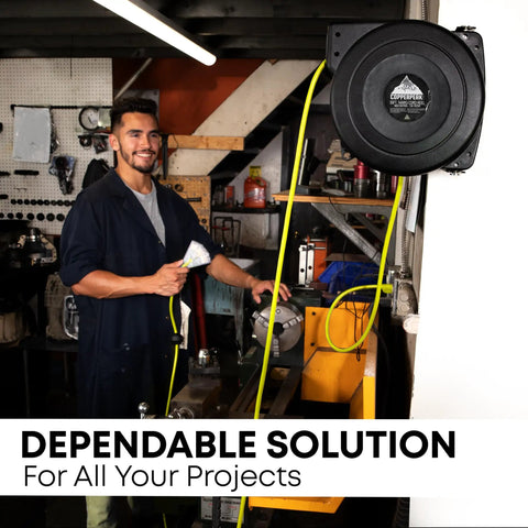 Man using Retractable Extension Cord Reel With 50 Ft Reach, 14 AWG, 3 Outlets, Ceiling Or Wall Mount, Yellow And Grey in workshop