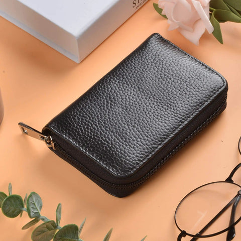 Genuine Leather Card Holder With Zipper Wallet For 26 Cards Black Slim And Durable Compact on beige surface with glasses