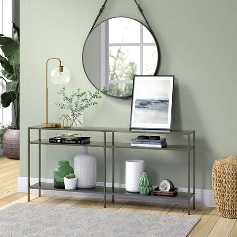 Living room with Lit 27 Inch Tall Arc Table Lamp With Clear Glass Globe Shade And Brass Accents on console table