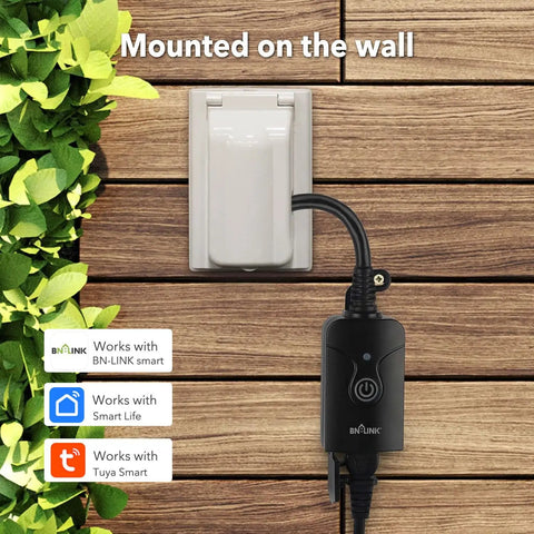 Outdoor Smart Plug With WiFi Remote App Control Alexa And Google Assistant Voice Control Weatherproof ETL Listed 2 4 GHz WiFi Required Super Handy With Smart Life App shown mounted on a wooden wall with surrounding green leaves.