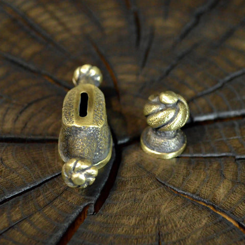 Close-up of Finger Guard Knife Making Kit With Bolster And Pommel For Custom Blades Hand Cast Bronze Set, on wood.