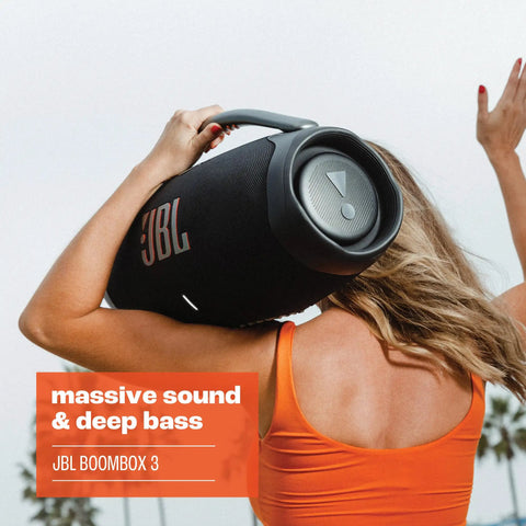 Person holding Boombox 3 Portable Bluetooth Speaker With Massive Sound And Deep Bass IPX7 Waterproof outdoors.