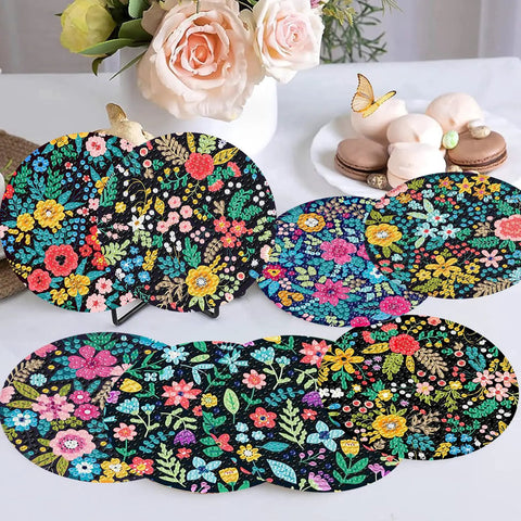 8 Pack Diamond Art Coasters Kit With Flower Designs showcasing colorful floral patterns on a table, with cork pads and holder visible.
