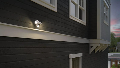 3-Light LED Outdoor Flood Light With Dusk To Dawn Sensor, Adjustable Lumens, mounted on black house exterior at dusk