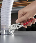 Hand using adjustable pliers wrench set 6 inch 7 inch 10 inch with smooth jaws and push button lock on plumbing pipe
