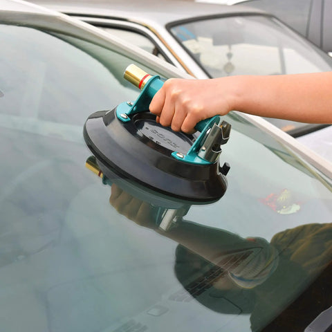 Heavy Duty 9 Inch Vacuum Concave Suction Cup for Granite and Glass Lifting with Metal Handle and Brass Pump in use on glass