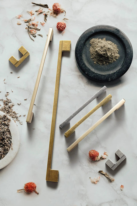 Six Pack Light Brushed Brass Cabinet Pulls Two Center To Center Lengths 7.5 Inches And 8.8 Inches Zinc Alloy Drawer Handles Kitchen Cabinet Hardware With M4 Screws For Easy Install displayed on marble surface with decorative elements