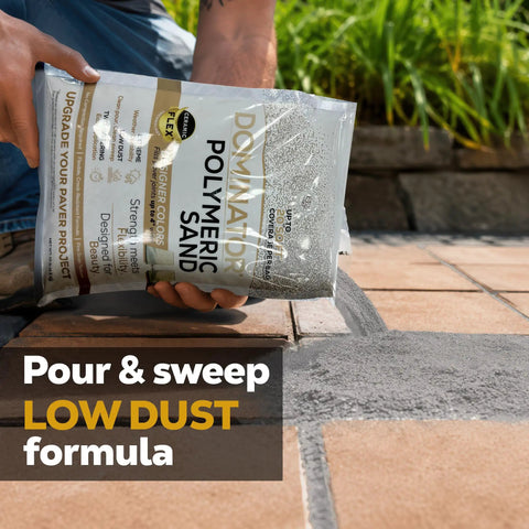 Person pouring Titanium Gray Heavy Duty Polymeric Sand For Patio Paver Joints And Stone Gaps Featuring Ceramic Flex Technology Killer Stability No Sweat Setup 10 Pound Bag onto paver joints.