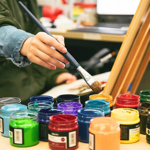 12 Pack 4 Oz Clear Plastic Sample Jars With Heavy Duty Black Screw Top Lids Super Portable Travel Cosmetic Storage Containers Perfect For Giveaways And Retail Displays A Total Bang For Your Buck Value Set with paintbrush above colorful jars.