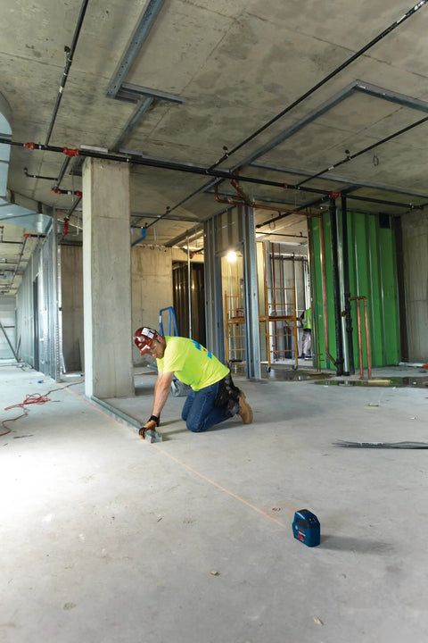 Construction worker using GLL 55 Self Leveling Cross Line Laser With Visimax Technology Delivers Bright Line Visibility On Real Jobsites