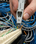 Pro Grade Impact Punch Down Tool And Integrated Wire Stripper RJ45 Crimping Kit For Cat6 Cat5e Ethernet Cables in use, trimming wires.