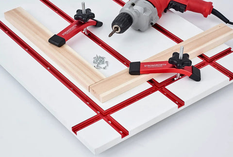 Heavy Duty Red Anodized T Track Hold Down Clamps With T Bolts And Washers For Woodworking And Milling Badass Shop Gear securing a wooden plank on a milling table.