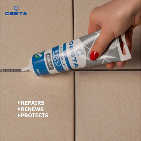 Hand using Tile Grout Repair Kit Squeeze Tube Fast Drying Waterproof Grout Paint to Restore and Renew Tile Joints for Bathroom Kitchen Shower Floor Tiles Grey 8.8 Oz With Precision Spatula and Easy Application for Diy Renovations on tile joint.