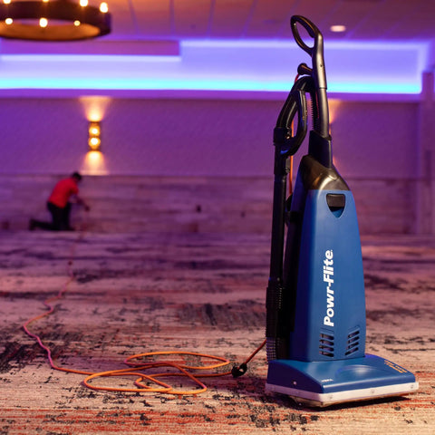 Powr-Flite Borelli Dual Pro Upright Vacuum With HEPA Filtration For Heavy Duty Commercial Use on a carpeted floor with extension cord.