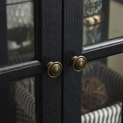 Close-up of black wood grain lattice doors with brass knobs on a 30 Inch Glass Curio Display Cabinet With LED Lighting