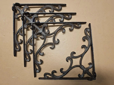 Four Sturdy Cast Iron Shelf Bracket Set 10 By 10 Inches, Ornate Fleur De Lis Design, Matte Brown Finish displayed on surface