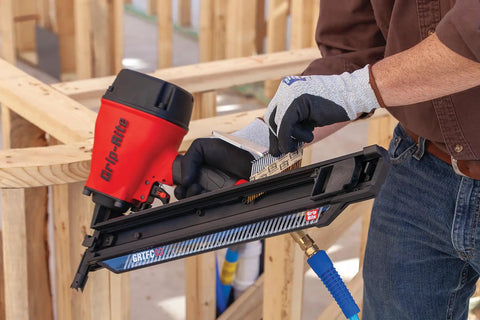 Person using a nail gun with 21 Degree Plastic Strip Round Head Framing Nails Bright Coated 3 In By 0.120 In Collated