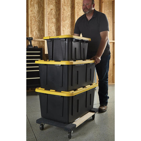 Man using Heavy Duty Moving Dolly Featuring Tough As Nails Hardwood Platform And Smooth Riding Nonmarking Rubber Casters For Zero Hassle Furniture Hauling Up To 1000 Pounds with stacked storage bins.