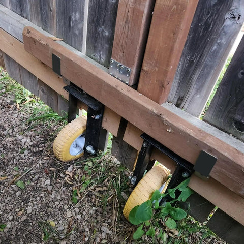Heavy Duty Door Barricade Brackets Pair Metal Security Lock Reinforcement Kit With Pin Hole Setup Keep The Creeps Off Your Porch And Lock Down The Entry Tight Quick mounted on a wooden gate with yellow wheels.