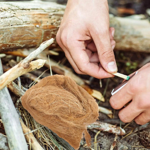 Lighting a match using the 4 Piece Jute Flame Starters Quick Ignition Reusable Outdoor Fire Starters for camping gear.