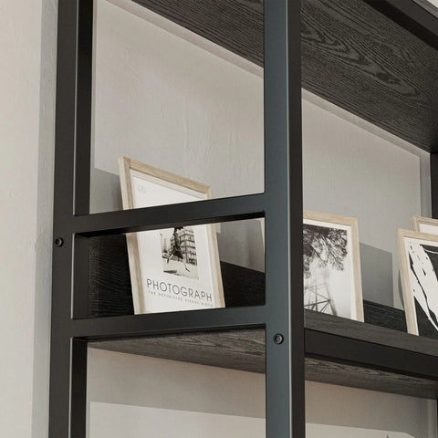 Close-up of FiveTier Industrial Corner Bookshelf With HeavyDuty Metal Frame showing framed photographs on a dark wood shelf.