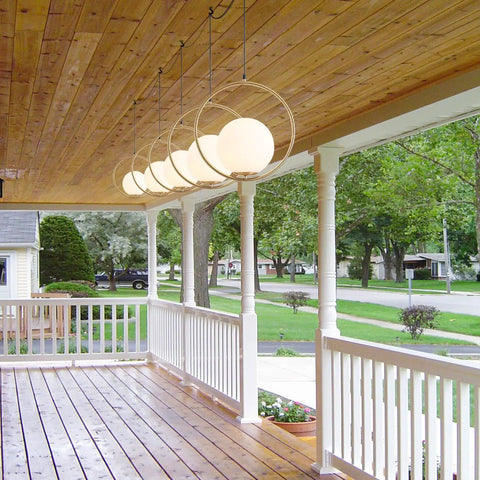 Plug In Globe Pendant Light Fixture With White Glass Ball And Brushed Brass Ring hanging on porch ceiling