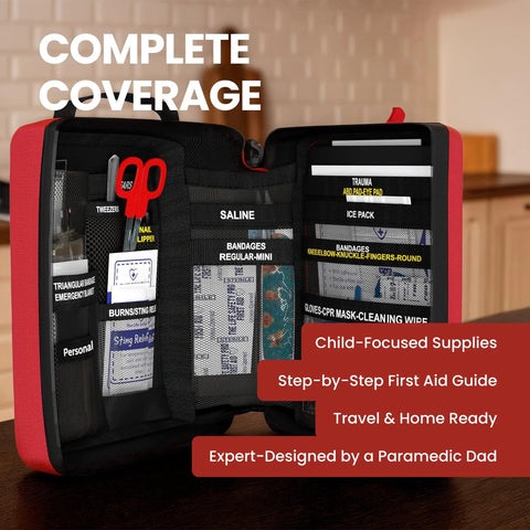 Red portable first aid kit for kids opened to reveal labeled pockets with saline, bandages, and ice packs