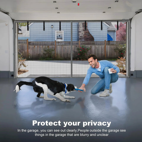 Man playing with dog in garage with Hands Free Magnetic Garage Door Screen in Privacy Silver, 9 by 7 feet installed.