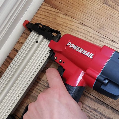 Heavy-Duty Pneumatic 18-Gauge Straight Brad Nailer Bad Boy with anodized aluminum magazine in use on flooring.