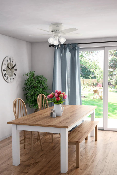 Dining room with table, chairs, and a 42 Inch Newsome Premier Bronze Low Profile Ceiling Fan With LED Light Kit above.