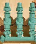 Heavy Duty 3 Valve Preassembled Irrigation Manifold with Swivel Unions for Quick No Fuss Multi Zone Valve Systems displayed on wood surface