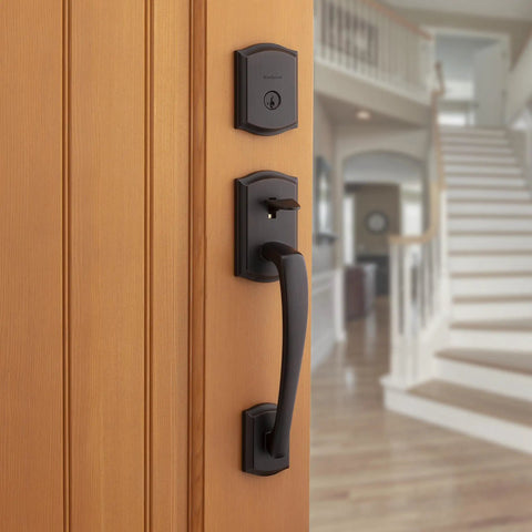 Prescott Front Door Lock Handle And Deadbolt Set, Exterior Handleset with Interior Reversible Lever, Venetian Bronze on wooden door
