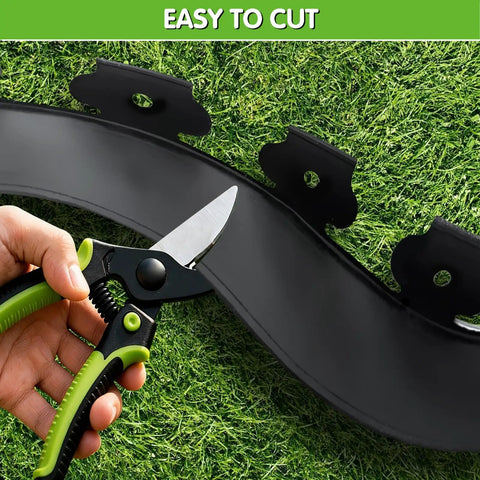 No Dig Garden Edging Kit 2 Inch Tall 20 Foot Border with 20 Stakes Plastic Lawn Edging being cut with scissors on grass