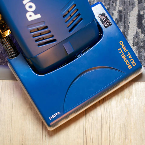 Powr-Flite Borelli Dual Pro Upright Vacuum With HEPA Filtration For Heavy Duty Commercial Use displayed on a wooden floor.