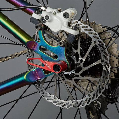 Ultralight Titanium Quick Release Skewer Set For Mountain Bike Red Beefed Up For Maximum Strength in rear wheel close-up view.