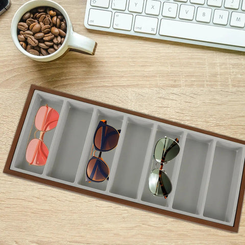 Top Shelf Walnut Wooden Sunglasses Tray With Silky Gray Velvet Liner, Roomy Seven Slot Eyewear Display Rack on a wooden desk.