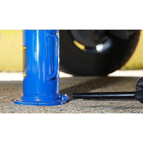 Badass 12 Ton Hydraulic Bottle Jack With High Grade Steel Welded Base For No Sweat Shop Grind Daily Auto Repair And Farm Hauling 15.94 To 18 Inch Lift Height Built Legit on the ground with a tire nearby.