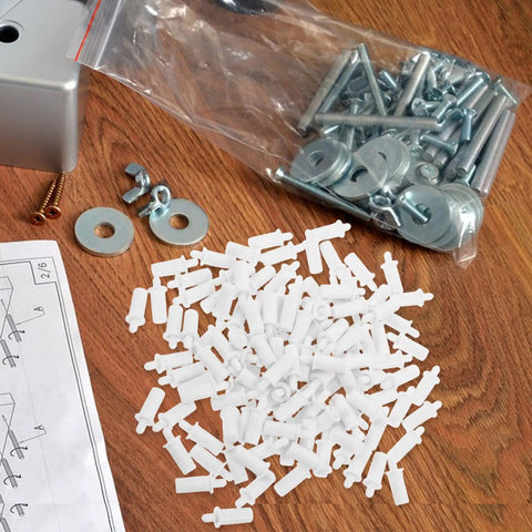 White Shutter Repair Pins, 120 Piece Movable Louver Fasteners scattered on a wooden surface with various hardware supplies.