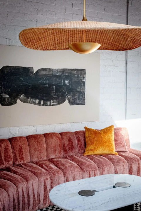 Totally Main Character Energy One Light Pendant Ceiling Light Fifty Two Inches Wide Vintage Gold Leaf Metal Dome Shade hanging above a cozy living room sofa.