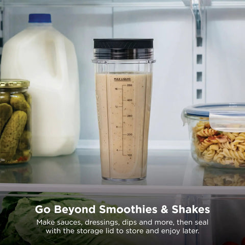 Heavy Duty Personal Blender Featuring 900W Push To Blend Motor And Pro Extractor Blades Crushing Ice For Nutrient Dense Smoothies Including Three Grab And Go 20 Oz Serveware Cups In Classic Silver in fridge with smoothie.