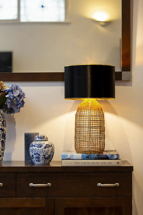 Dope Black Drum Lampshade With Spider Fitter And Harp Compatibility, 13 Inch Diameter And 8.5 Inch Height on a wicker base in room
