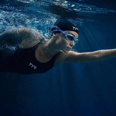 Crush The Daily Lap Grind With These Nest Frame Swim Goggles Locked In With Smoke Tint Wide Peripheral Vision And Tough Unibody Construction For Peak Pool Visibility, swimmer wearing black suit underwater.