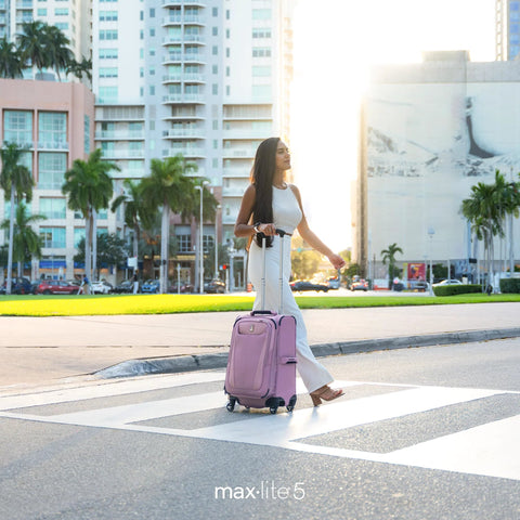 Woman crossing street with ultra lightweight carry on luggage