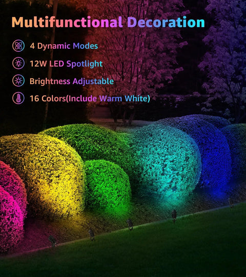 Outdoor bushes lit by 12W RGBW landscape lights in multiple colors with remote control in a garden setting.
